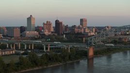5.7K aerial stock footage focus on the city's skyline behind the bridge at sunset, Downtown Memphis, Tennessee Aerial Stock Footage | DX0002_181_019