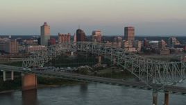 5.7K aerial stock footage of ascending past the the bridge at sunset for a view of Downtown Memphis, Tennessee Aerial Stock Footage | DX0002_181_022