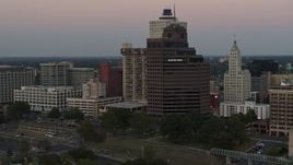 5.7K aerial stock footage flying by and office high-rise at sunset in Downtown Memphis, Tennessee Aerial Stock Footage | DX0002_181_030