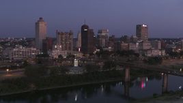 5.7K aerial stock footage a stationary view across Wolf River Harbor at the city's skyline at twilight in Downtown Memphis, Tennessee Aerial Stock Footage | DX0002_182_002