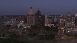 5.7K aerial stock footage of ascend away from office high-rises at twilight in Downtown Memphis, Tennessee Aerial Stock Footage | DX0002_182_005