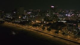 5.7K aerial stock footage approach downtown office buildings and tilt to city street at night, Downtown Memphis, Tennessee Aerial Stock Footage | DX0002_182_013