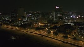 5.7K aerial stock footage of flying by and away from office buildings and towers at night in Downtown Memphis, Tennessee Aerial Stock Footage | DX0002_182_021