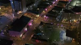 5.7K aerial stock footage ascend away from intersection of Beale Street and BB King Boulevard at night in Downtown Memphis, Tennessee Aerial Stock Footage | DX0002_182_046