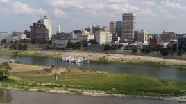 5.7K aerial stock footage flying low over the river toward the city's skyline in Downtown Memphis, Tennessee Aerial Stock Footage | DX0002_183_012