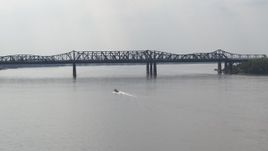 5.7K aerial stock footage of a boat speeding across the Mississippi River toward Harahan Bridge, Memphis, Tennessee Aerial Stock Footage | DX0002_183_021