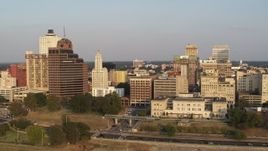 5.7K aerial stock footage orbit Raymond James Tower and city buildings at sunset, Downtown Memphis, Tennessee Aerial Stock Footage | DX0002_186_009