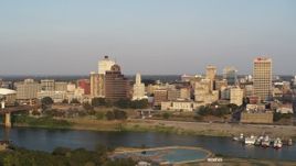 5.7K aerial stock footage fly away from Raymond James Tower for wider view of skyline at sunset, Downtown Memphis, Tennessee Aerial Stock Footage | DX0002_186_010