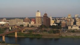 5.7K aerial stock footage of apartment complex and neighboring office tower by bridge at sunset, Downtown Memphis, Tennessee Aerial Stock Footage | DX0002_186_020
