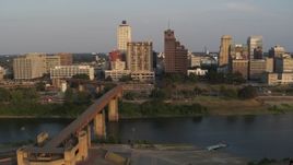 5.7K aerial stock footage of the welcome center, bridge, apartment complex and office tower at sunset, Downtown Memphis, Tennessee Aerial Stock Footage | DX0002_186_023