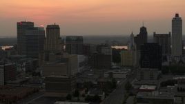5.7K aerial stock footage circling office towers with view of setting sun, Downtown Memphis, Tennessee Aerial Stock Footage | DX0002_186_033