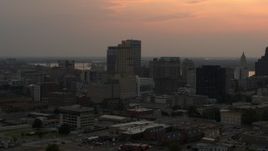 5.7K aerial stock footage of office high-rises with the setting sun in the sky, Downtown Memphis, Tennessee Aerial Stock Footage | DX0002_186_034