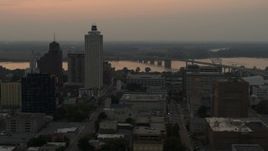 5.7K aerial stock footage of office towers at sunset, with river and bridge in background, Downtown Memphis, Tennessee Aerial Stock Footage | DX0002_186_040