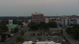 5.7K aerial stock footage a view of a hospital at twilight during descent in Memphis, Tennessee Aerial Stock Footage | DX0002_186_045