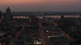 5.7K aerial stock footage fly away from and past Hernando de Soto Bridge, seen from Downtown Memphis, Tennessee at twilight Aerial Stock Footage | DX0002_187_009
