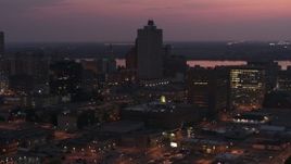 5.7K aerial stock footage of the 100 North Main office tower at twilight, Downtown Memphis, Tennessee Aerial Stock Footage | DX0002_187_017