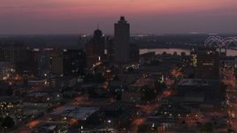 5.7K aerial stock footage of the 100 North Main office tower near the bridge at twilight, Downtown Memphis, Tennessee Aerial Stock Footage | DX0002_187_018