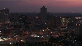 5.7K aerial stock footage approach and orbit the 100 North Main office tower at twilight, Downtown Memphis, Tennessee Aerial Stock Footage | DX0002_187_019
