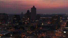 5.7K aerial stock footage fly toward and away from the 100 North Main office tower at twilight, Downtown Memphis, Tennessee Aerial Stock Footage | DX0002_187_020