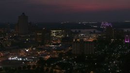 5.7K aerial stock footage city buildings between office tower and bridge at night, Downtown Memphis, Tennessee Aerial Stock Footage | DX0002_187_026