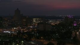 5.7K aerial stock footage orbit city buildings between office tower and bridge at night, Downtown Memphis, Tennessee Aerial Stock Footage | DX0002_187_027
