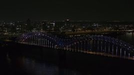 5.7K aerial stock footage of the skyline seen from the bridge with colorful lights at night, Downtown Memphis, Tennessee Aerial Stock Footage | DX0002_187_039