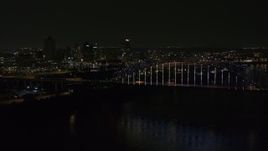 5.7K aerial stock footage of flying away from the skyline and bridge with colorful lights at night, Downtown Memphis, Tennessee Aerial Stock Footage | DX0002_187_041