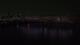 5.7K aerial stock footage static view of the skyline and the bridge with colorful lights at night, Downtown Memphis, Tennessee Aerial Stock Footage | DX0002_187_045