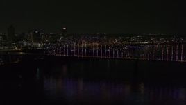 5.7K aerial stock footage slowly fly to the bridge with colorful lights and skyline at night, Downtown Memphis, Tennessee Aerial Stock Footage | DX0002_187_047