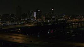 5.7K aerial stock footage view of the skyline while descending near the bridge at night, Downtown Memphis, Tennessee Aerial Stock Footage | DX0002_187_054