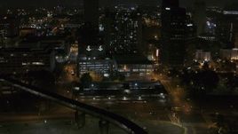 5.7K aerial stock footage approaching apartment high-rise and parking garage at night, Downtown Memphis, Tennessee Aerial Stock Footage | DX0002_187_065