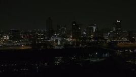 5.7K aerial stock footage of the city's downtown skyline at nighttime while descending, Downtown Memphis, Tennessee Aerial Stock Footage | DX0002_187_070