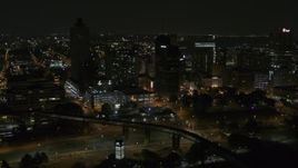 5.7K aerial stock footage of ascending toward the city's downtown skyline at nighttime, Downtown Memphis, Tennessee Aerial Stock Footage | DX0002_187_071