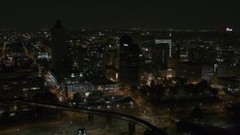 5.7K aerial stock footage fly away from high-rises for wider view of the city's skyline at nighttime, Downtown Memphis, Tennessee Aerial Stock Footage | DX0002_187_072