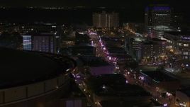 5.7K aerial stock footage flyby arena to reveal Beale Street at nighttime, Downtown Memphis, Tennessee Aerial Stock Footage | DX0002_188_002