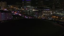 5.7K aerial stock footage of Beale Street at nighttime while descending by arena, Downtown Memphis, Tennessee Aerial Stock Footage | DX0002_188_012