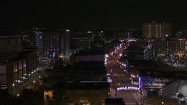 5.7K aerial stock footage of flying past busy Beale Street at nighttime, Downtown Memphis, Tennessee Aerial Stock Footage | DX0002_188_018