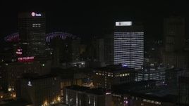 5.7K aerial stock footage of flying away from an office tower at nighttime, Downtown Memphis, Tennessee Aerial Stock Footage | DX0002_188_023