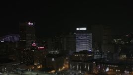 5.7K aerial stock footage of a reverse view of an office tower at nighttime, Downtown Memphis, Tennessee Aerial Stock Footage | DX0002_188_024