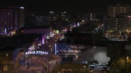 5.7K aerial stock footage of passing the Beale Street sign at nighttime, Downtown Memphis, Tennessee Aerial Stock Footage | DX0002_188_033