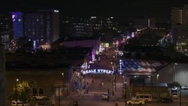 5.7K aerial stock footage orbit the Beale Street sign for view down the street at nighttime, Downtown Memphis, Tennessee Aerial Stock Footage | DX0002_188_034