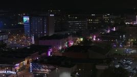 5.7K aerial stock footage flyby trees to reveal the Beale Street sign and clubs and restaurants at nighttime, Downtown Memphis, Tennessee Aerial Stock Footage | DX0002_188_041