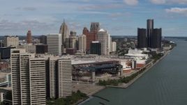 5.7K aerial stock footage of flyby apartment complex toward arena and skyline, Downtown Detroit, Michigan Aerial Stock Footage | DX0002_189_003