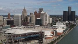 5.7K aerial stock footage of flying by the arena and convention center to approach skyline, Downtown Detroit, Michigan Aerial Stock Footage | DX0002_189_005