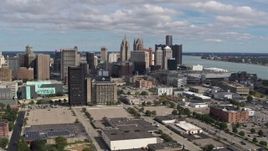 5.7K aerial stock footage the skyline behind office buildings, Downtown Detroit, Michigan Aerial Stock Footage | DX0002_189_026
