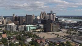 5.7K aerial stock footage approach the skyline behind office buildings, Downtown Detroit, Michigan Aerial Stock Footage | DX0002_189_027