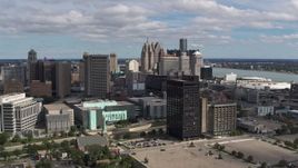 5.7K aerial stock footage flying by office buildings with a view of the skyline, Downtown Detroit, Michigan Aerial Stock Footage | DX0002_189_028