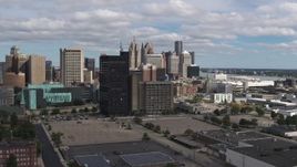 5.7K aerial stock footage descend with view of office buildings, skyline in background, Downtown Detroit, Michigan Aerial Stock Footage | DX0002_189_032