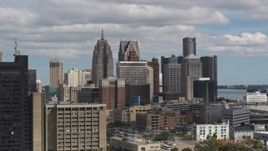 5.7K aerial stock footage ascend near office buildings to focus on the skyline, Downtown Detroit, Michigan Aerial Stock Footage | DX0002_189_036