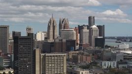 5.7K aerial stock footage of the city's towering skyscrapers, descend near office buildings, Downtown Detroit, Michigan Aerial Stock Footage | DX0002_189_040
